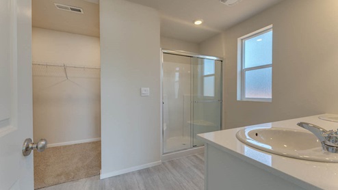 primary bathroom with a walk-in shower with bench seats