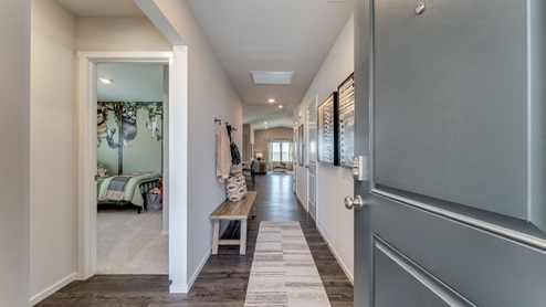 Entryway with a coat closet and laminate flooring