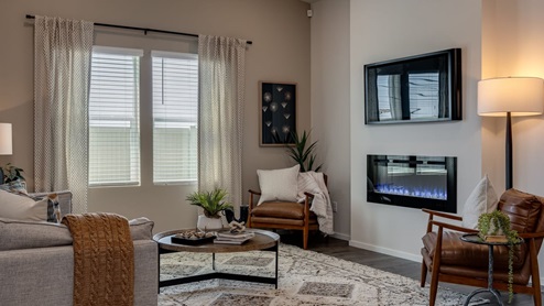 Great room with laminate flooring and an electric fireplace and vaulted ceilings