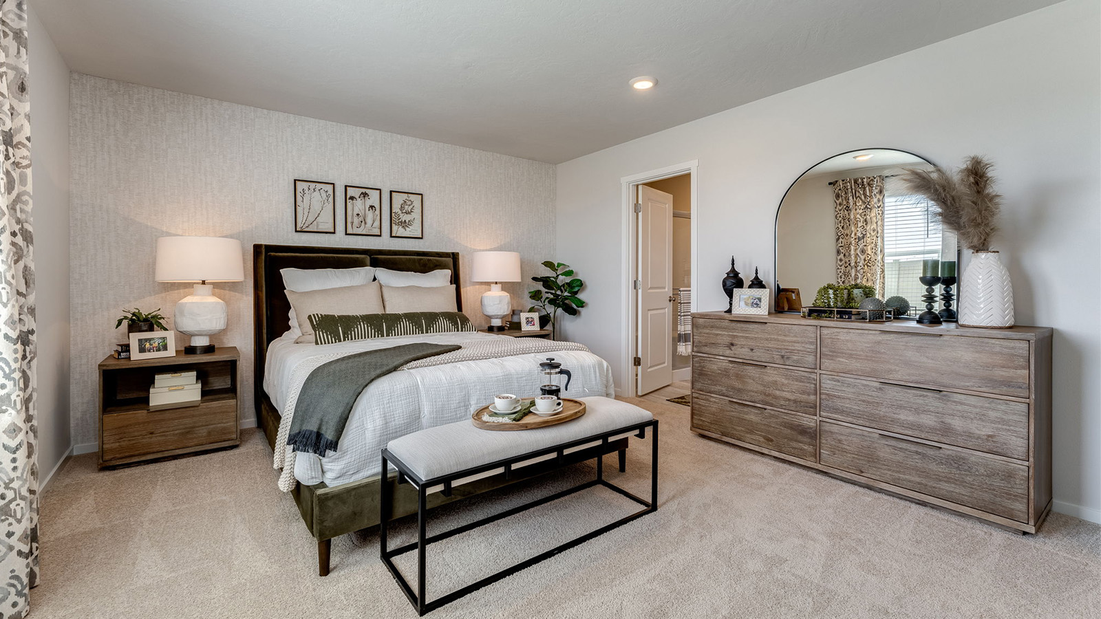Primary bedroom with wall-to-wall carpet, a walk-in closet and an attached bathroom