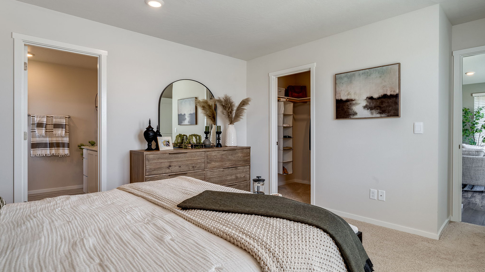Primary bedroom with wall-to-wall carpet, a walk-in closet and an attached bathroom