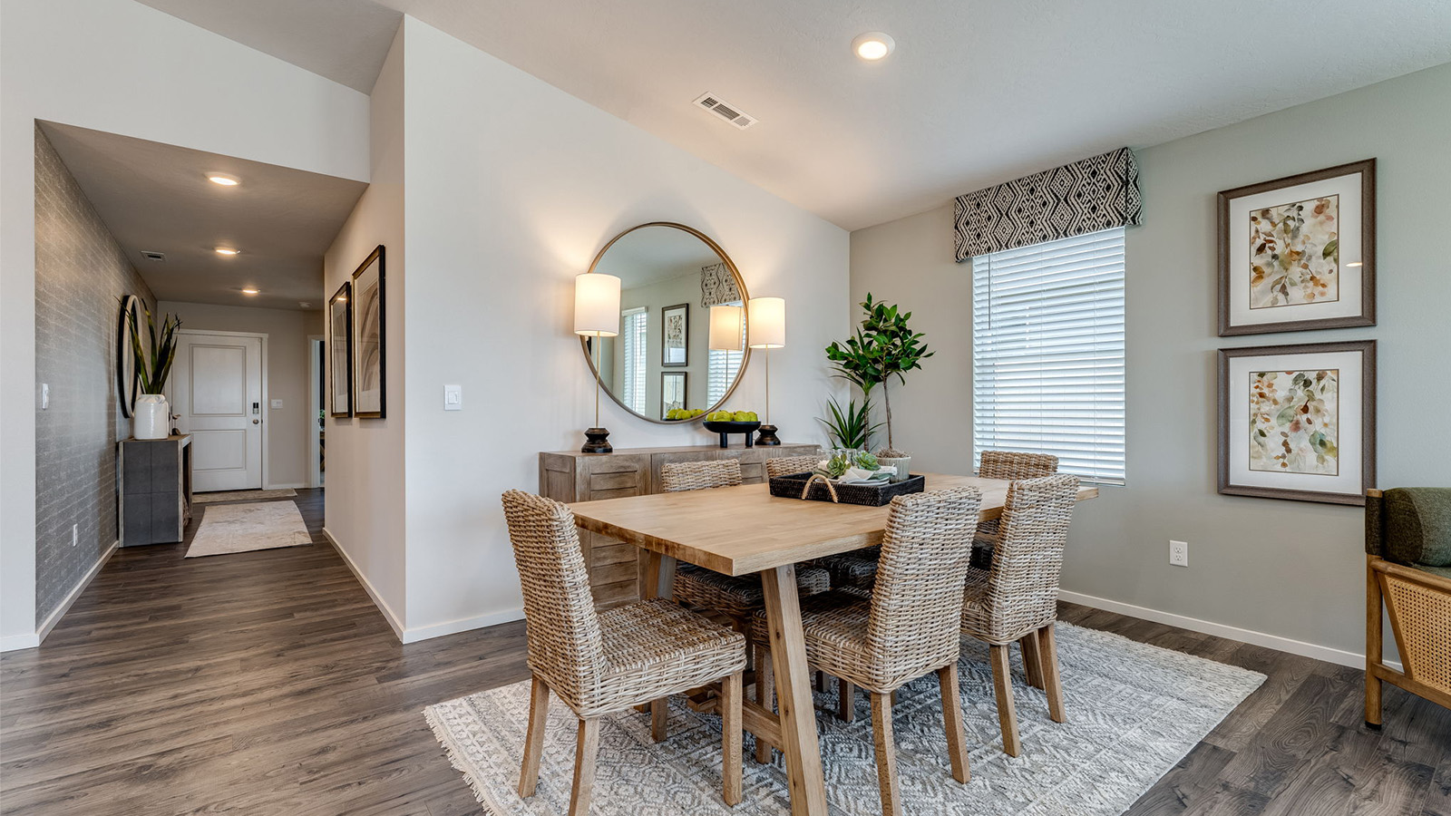 Great room with laminate flooring and an electric fireplace and vaulted ceilings