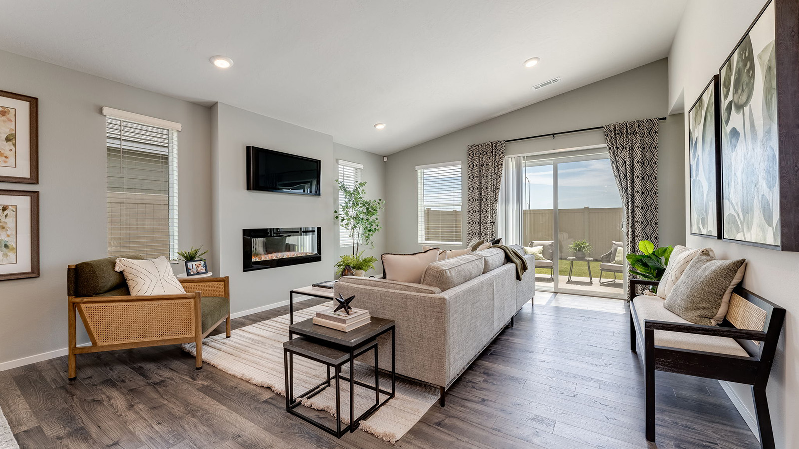 Great room with laminate flooring and an electric fireplace and vaulted ceilings