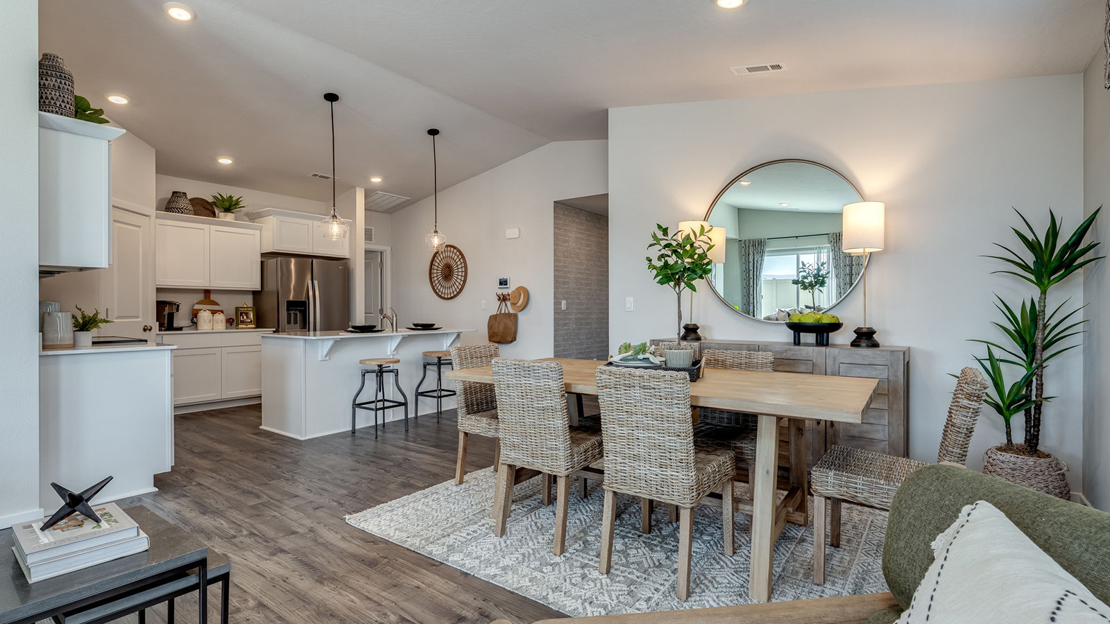 Kitchen with shaker cabinets, quartz counters, stainless steel appliances, pantry, and an island with a breakfast bar