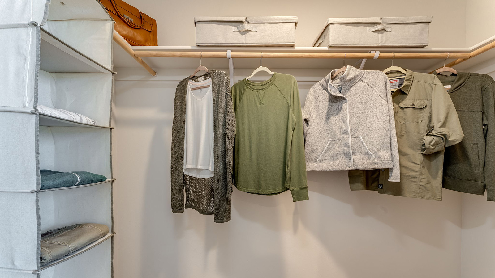 Primary bedroom walk-in closet with built-in shelves