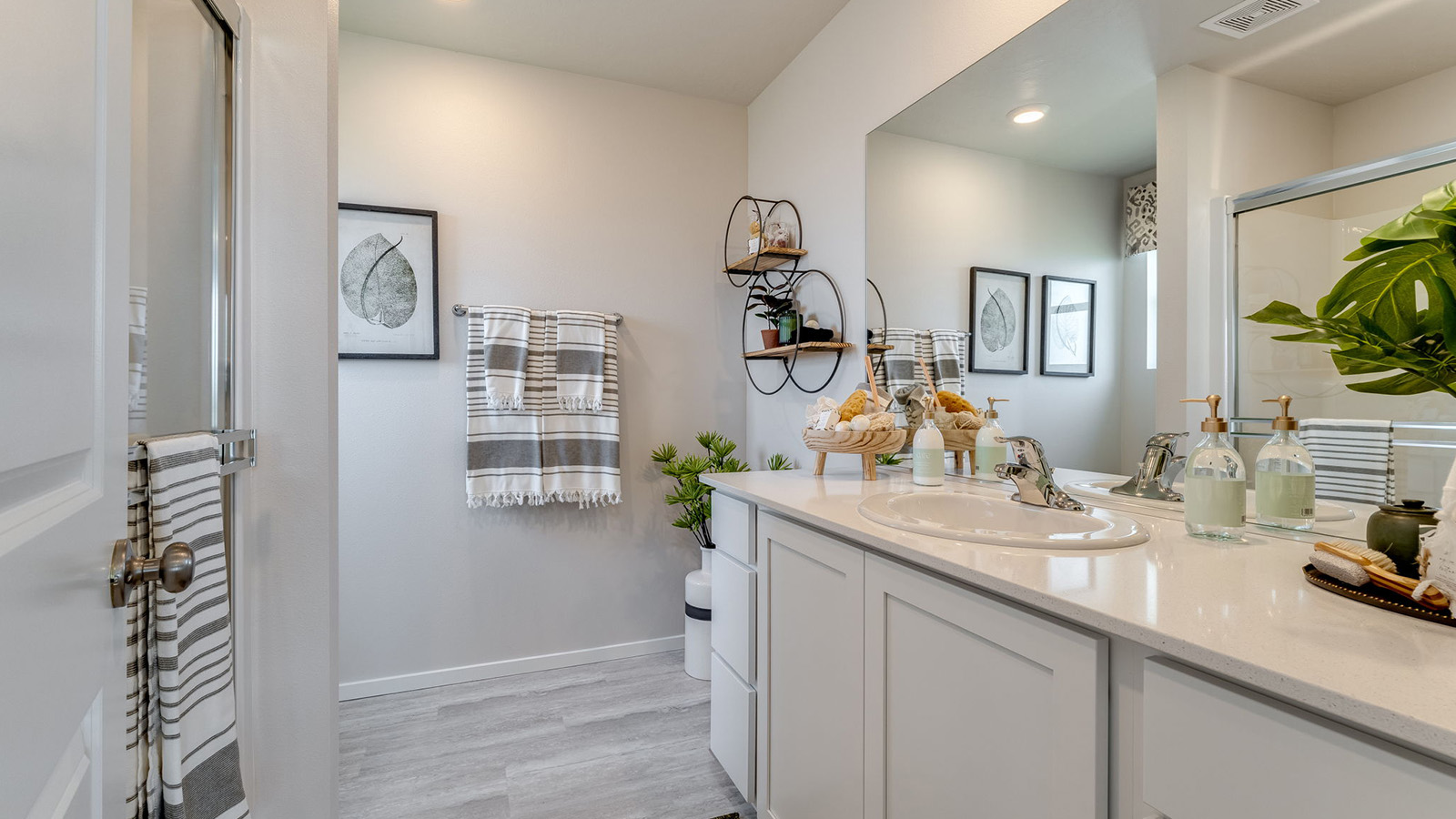 Primary bathroom with quartz counters and a walk-in shower