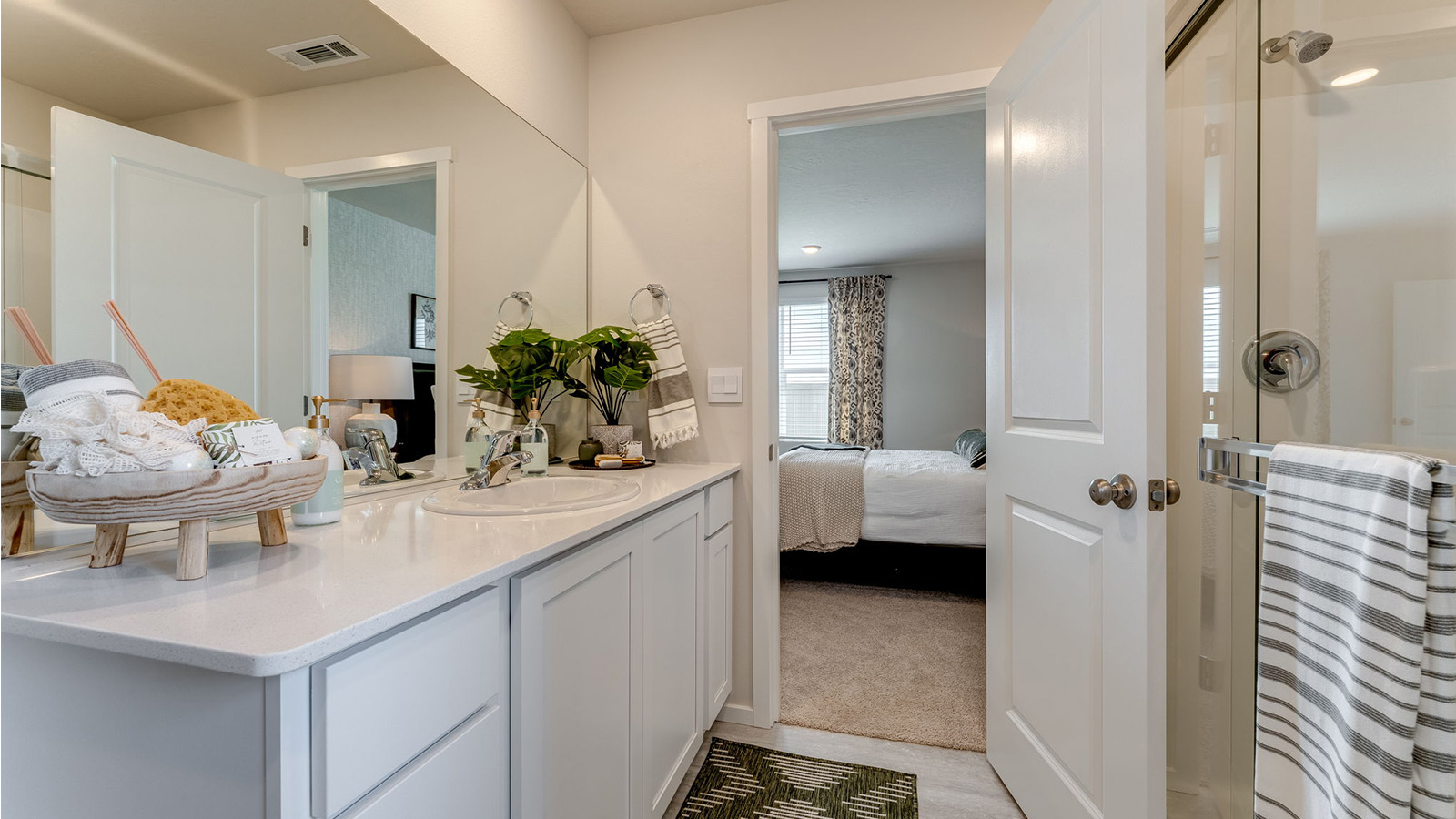 Primary bathroom with quartz counters and a walk-in shower