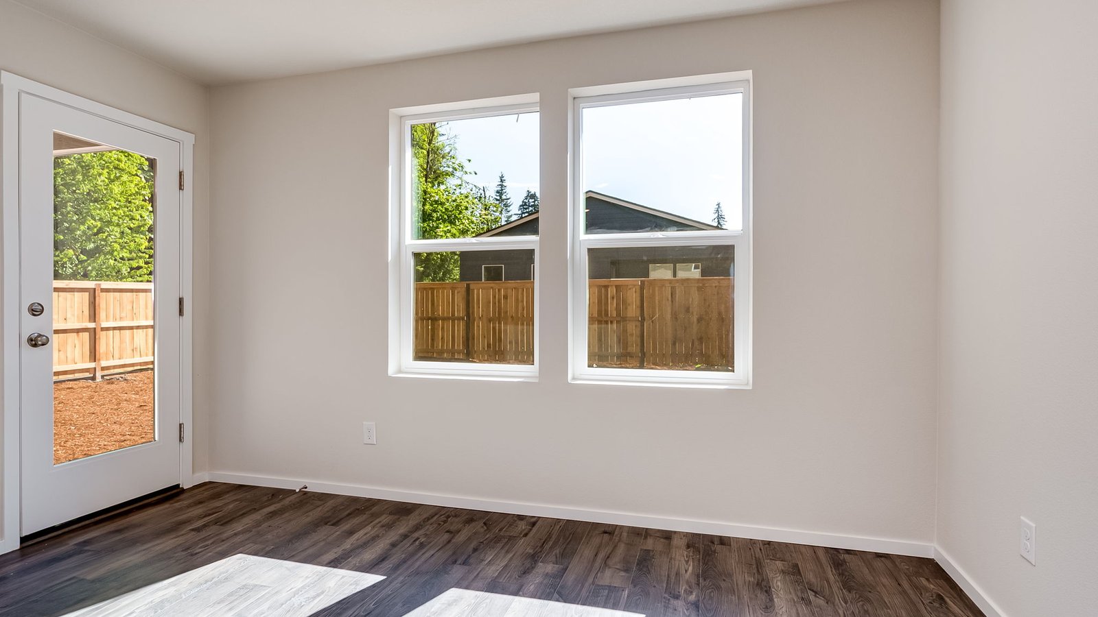 Dining area with a sliding glass door to a fenced backyard