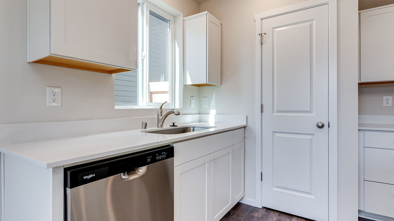 Kitchen with shaker cabinets, quartz counters, stainless steel appliances, pantry, and an island with a breakfast bar