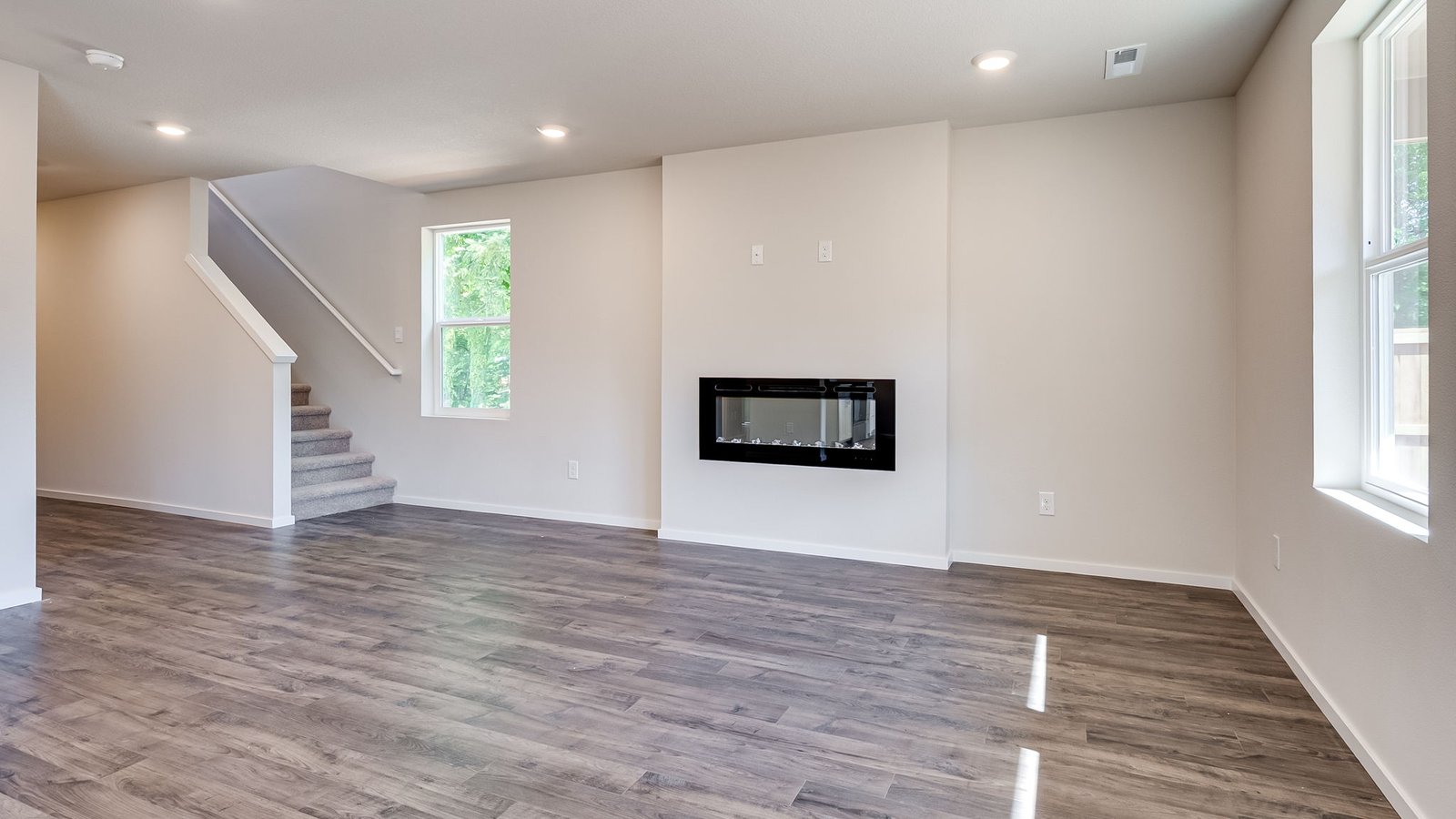 Great room with laminate flooring and an electric fireplace