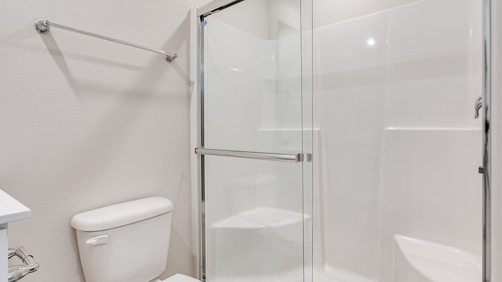 bathroom with quartz counters and a walk-in shower