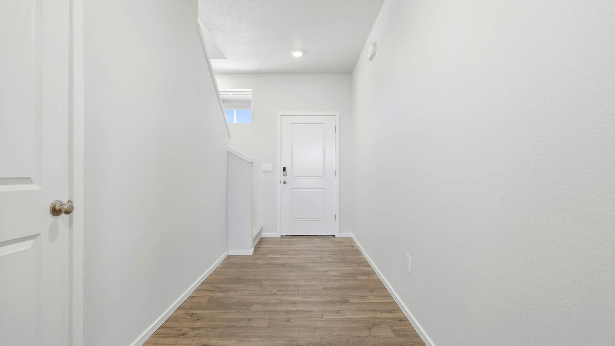 Entryway with a coat closet and laminate flooring