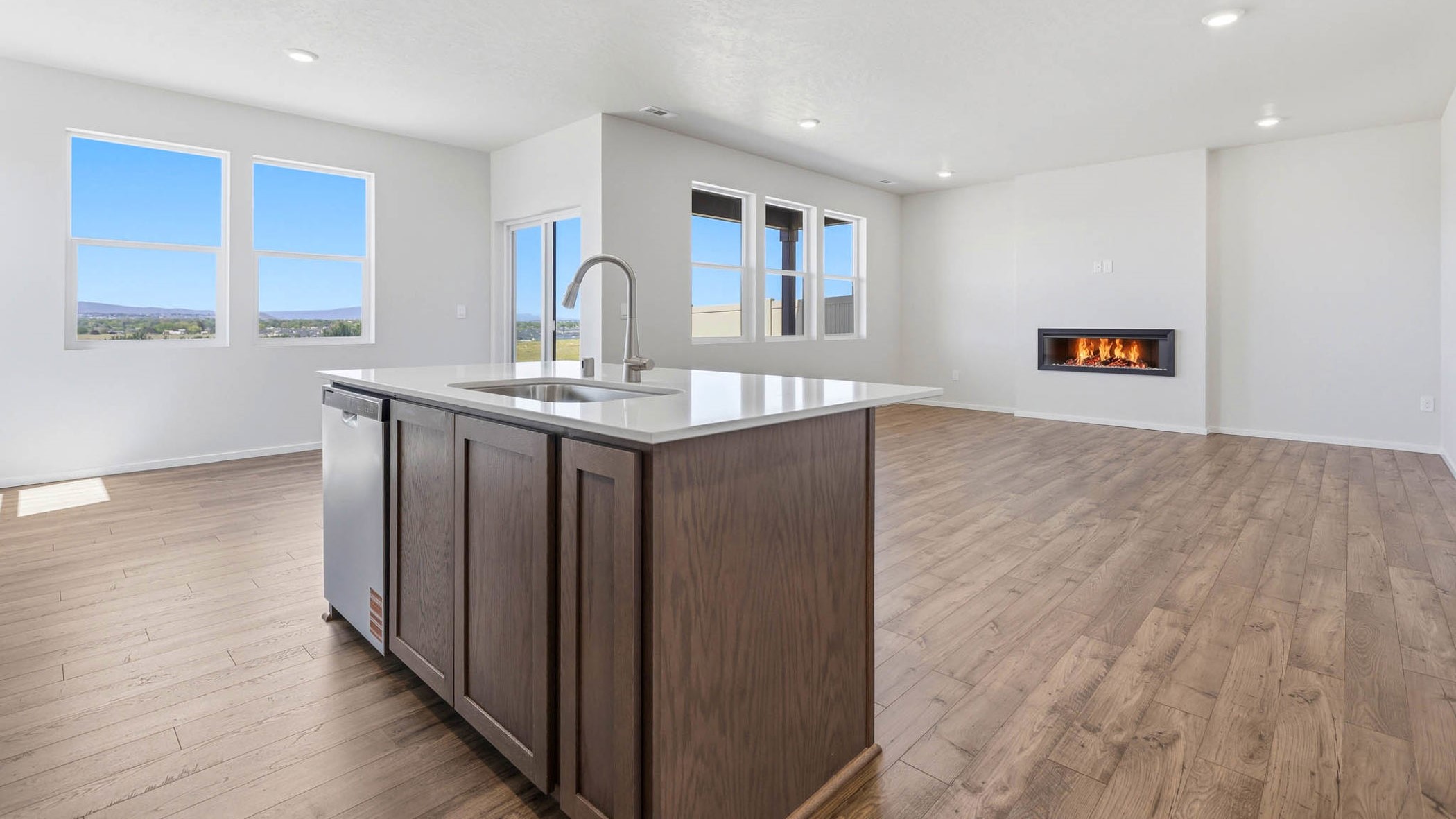 Kitchen with shaker cabinets, quartz counters, stainless steel appliances, pantry, and an island with a breakfast bar
