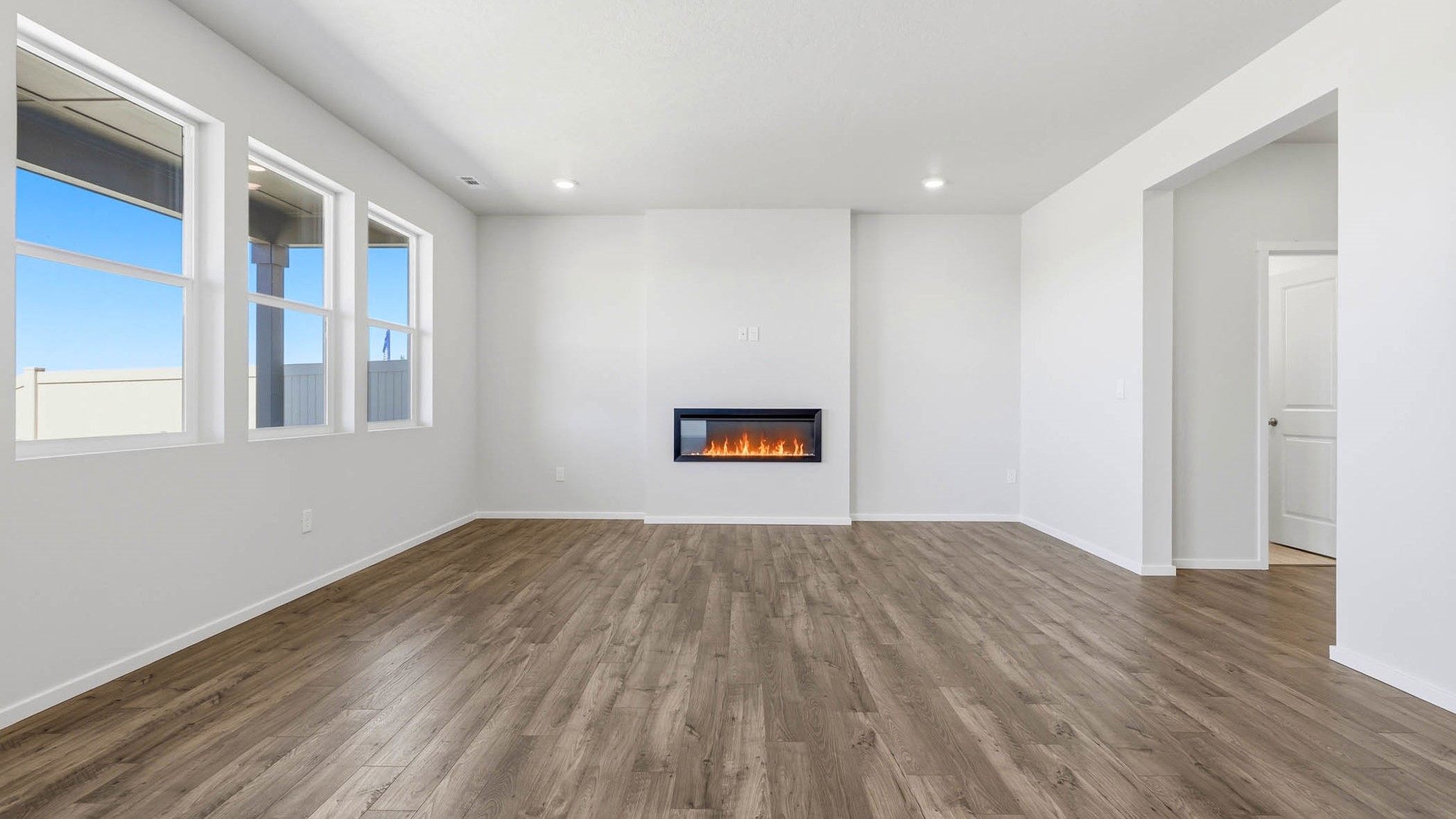 Great room with laminate flooring and an electric fireplace