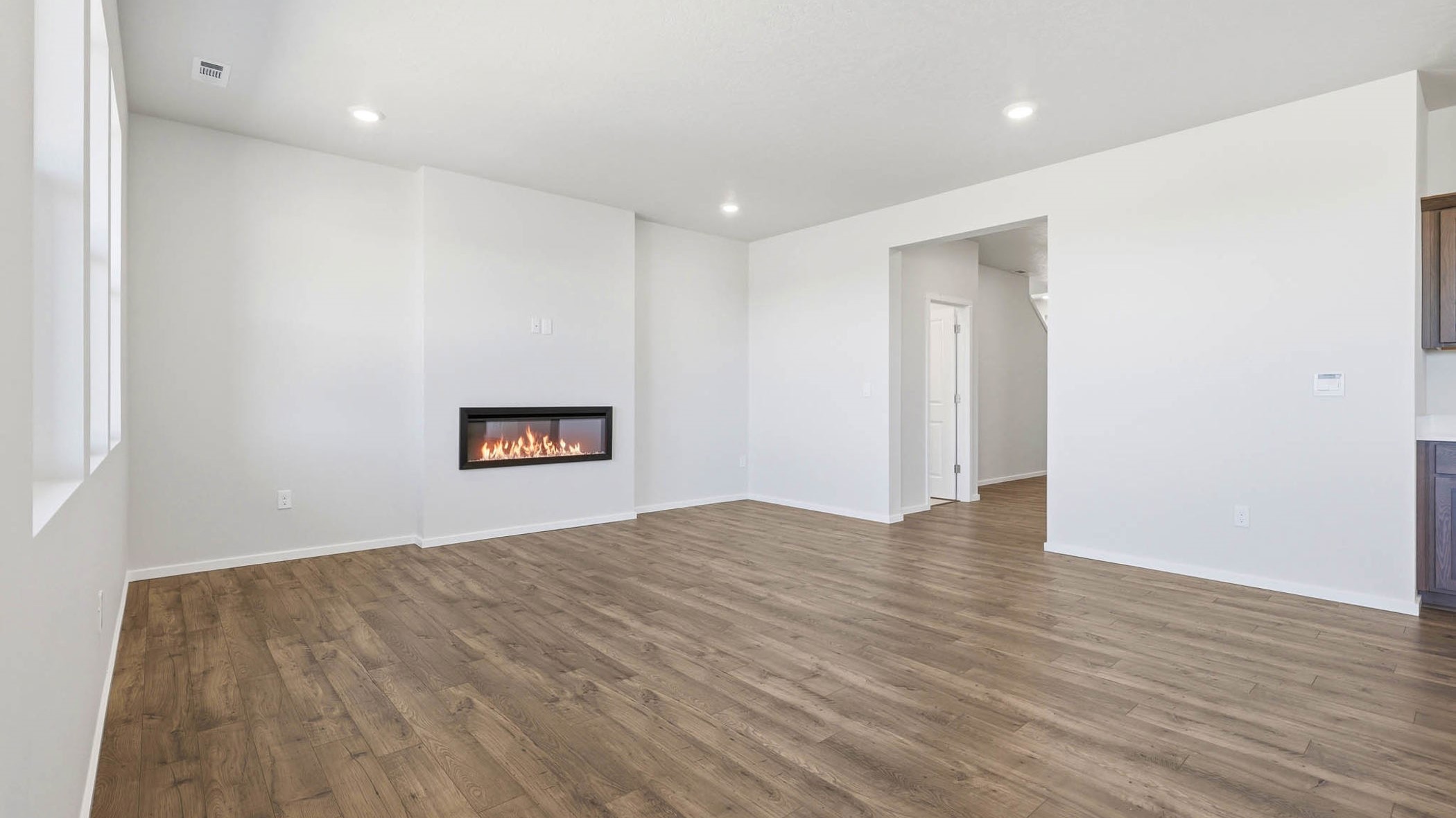 Great room with laminate flooring and an electric fireplace