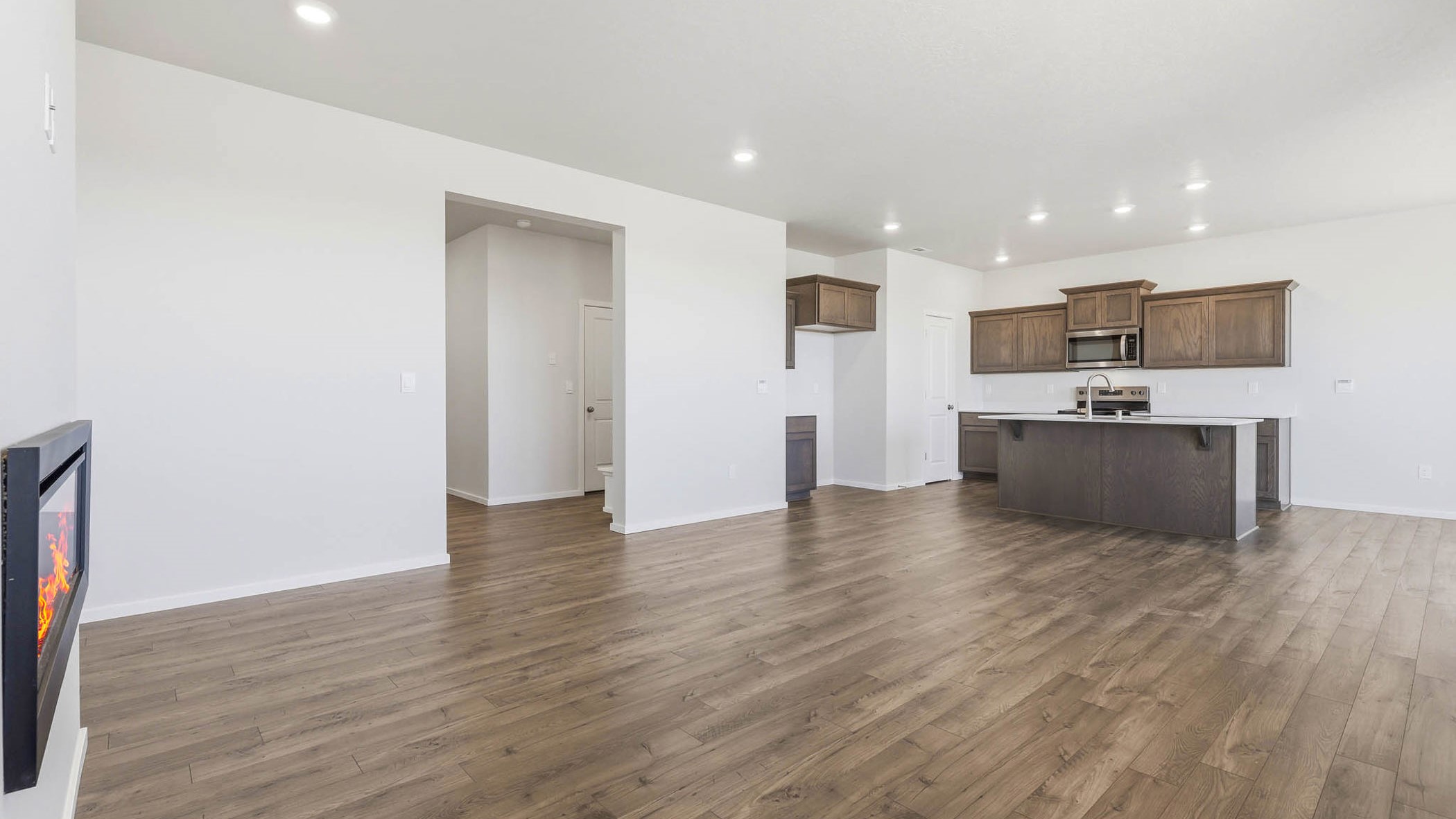 Great room with laminate flooring and an electric fireplace