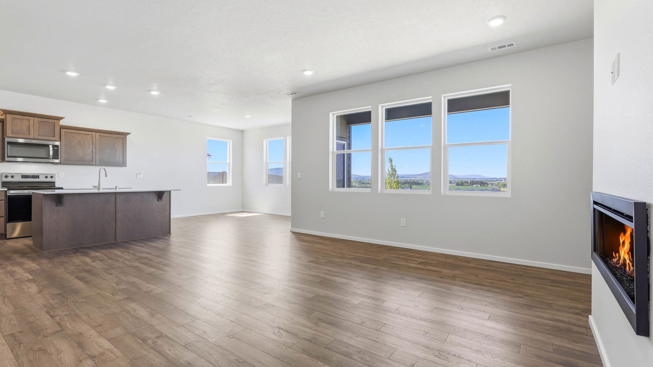 Great room with laminate flooring and an electric fireplace
