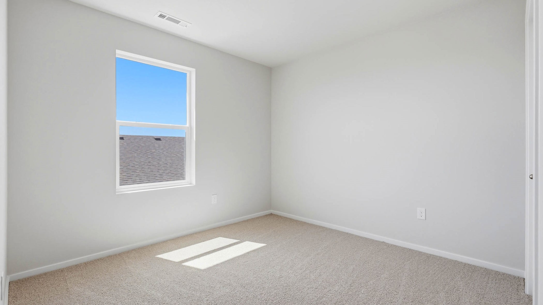 Bedroom with wall-to-wall carpet and a closet