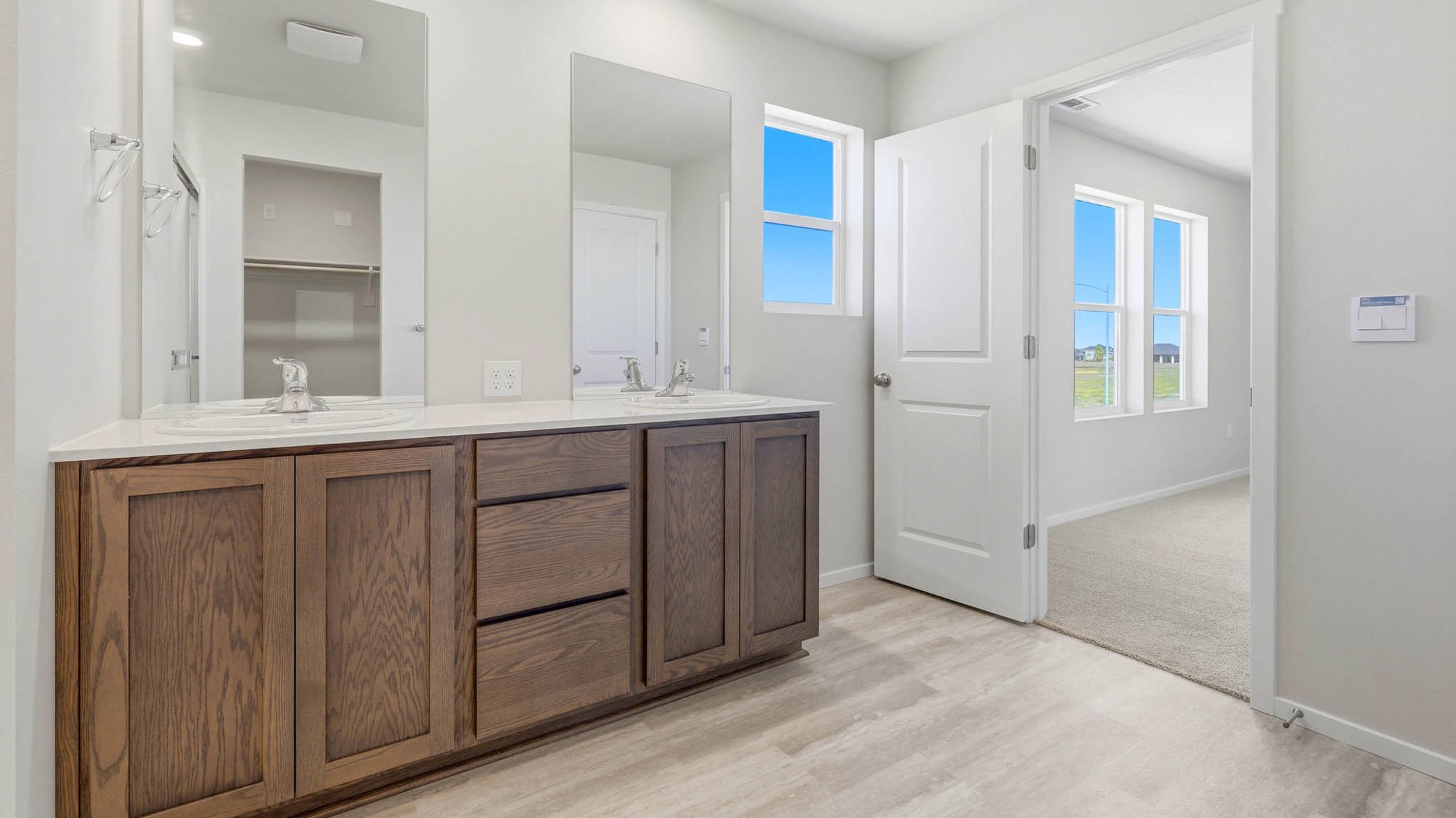 Primary bathroom with quartz counters and a walk-in shower