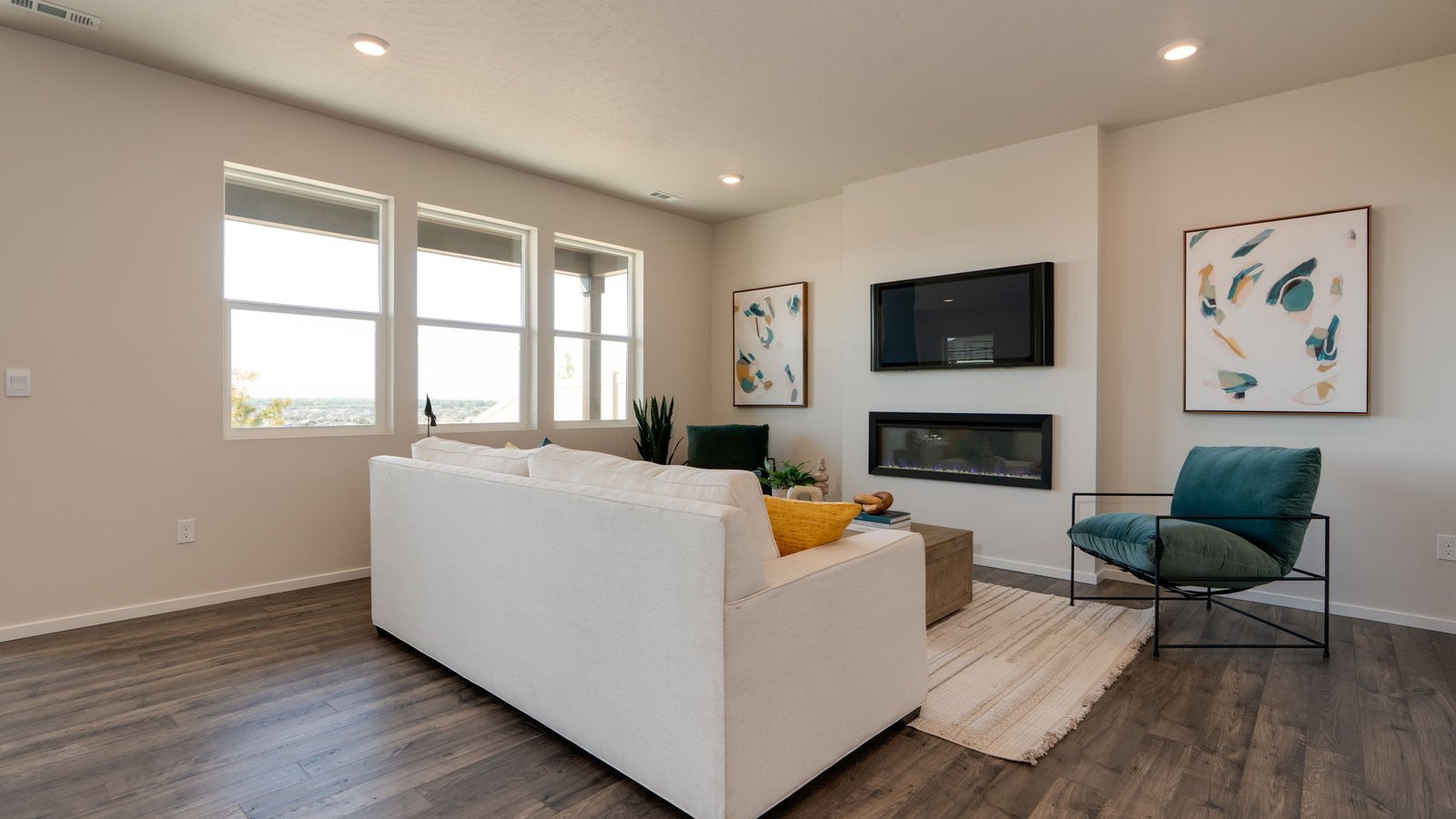 Great room with laminate flooring and an electric fireplace
