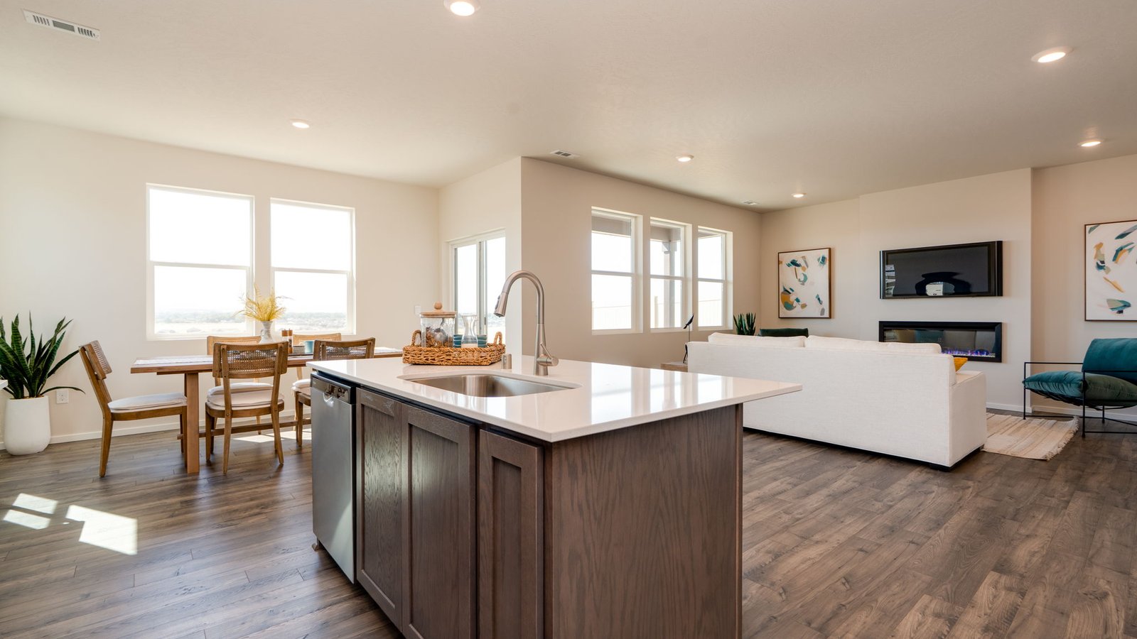 Kitchen with shaker cabinets, quartz counters, stainless steel appliances, pantry, and an island with a breakfast bar