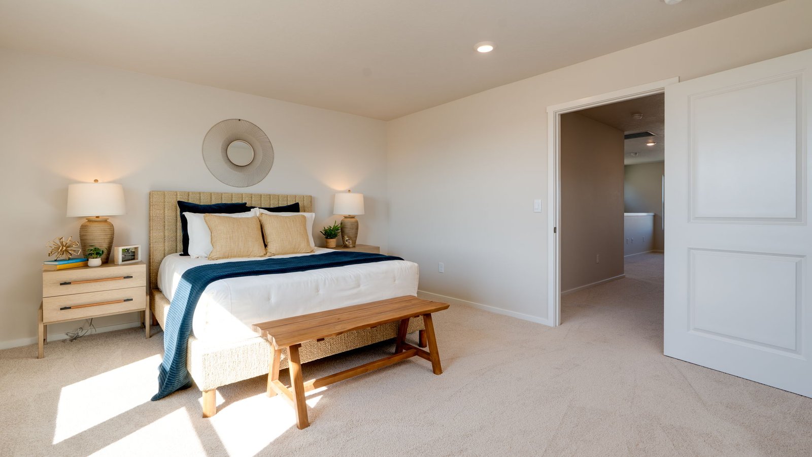 Primary bedroom with wall-to-wall carpet, a walk-in closet and an attached bathroom
