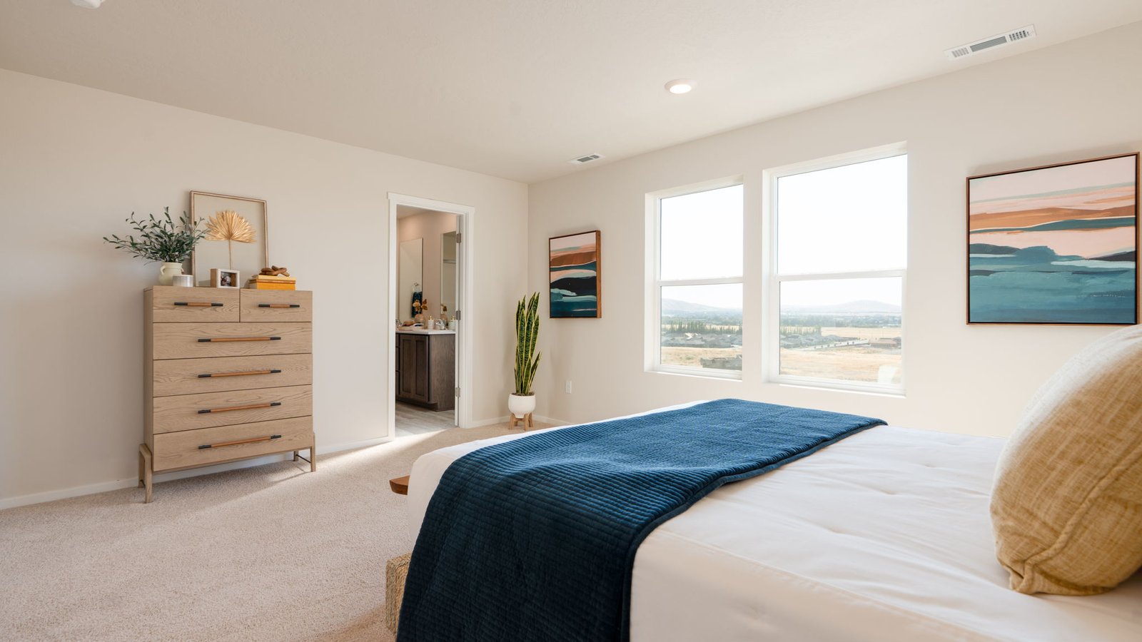 Primary bedroom with wall-to-wall carpet, a walk-in closet and an attached bathroom