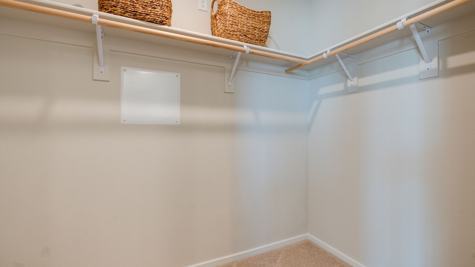 Primary bedroom walk-in closet with built-in shelves