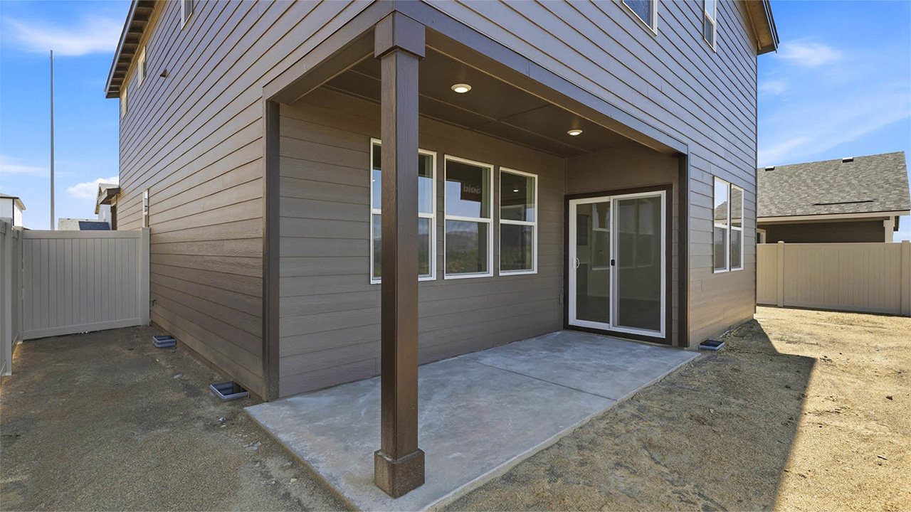 backyard with vinyl plank fence and covered patio