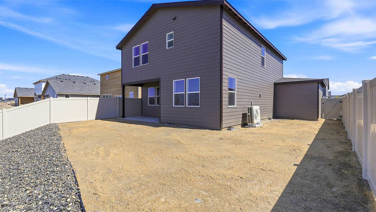 backyard with vinyl plank fence and covered patio