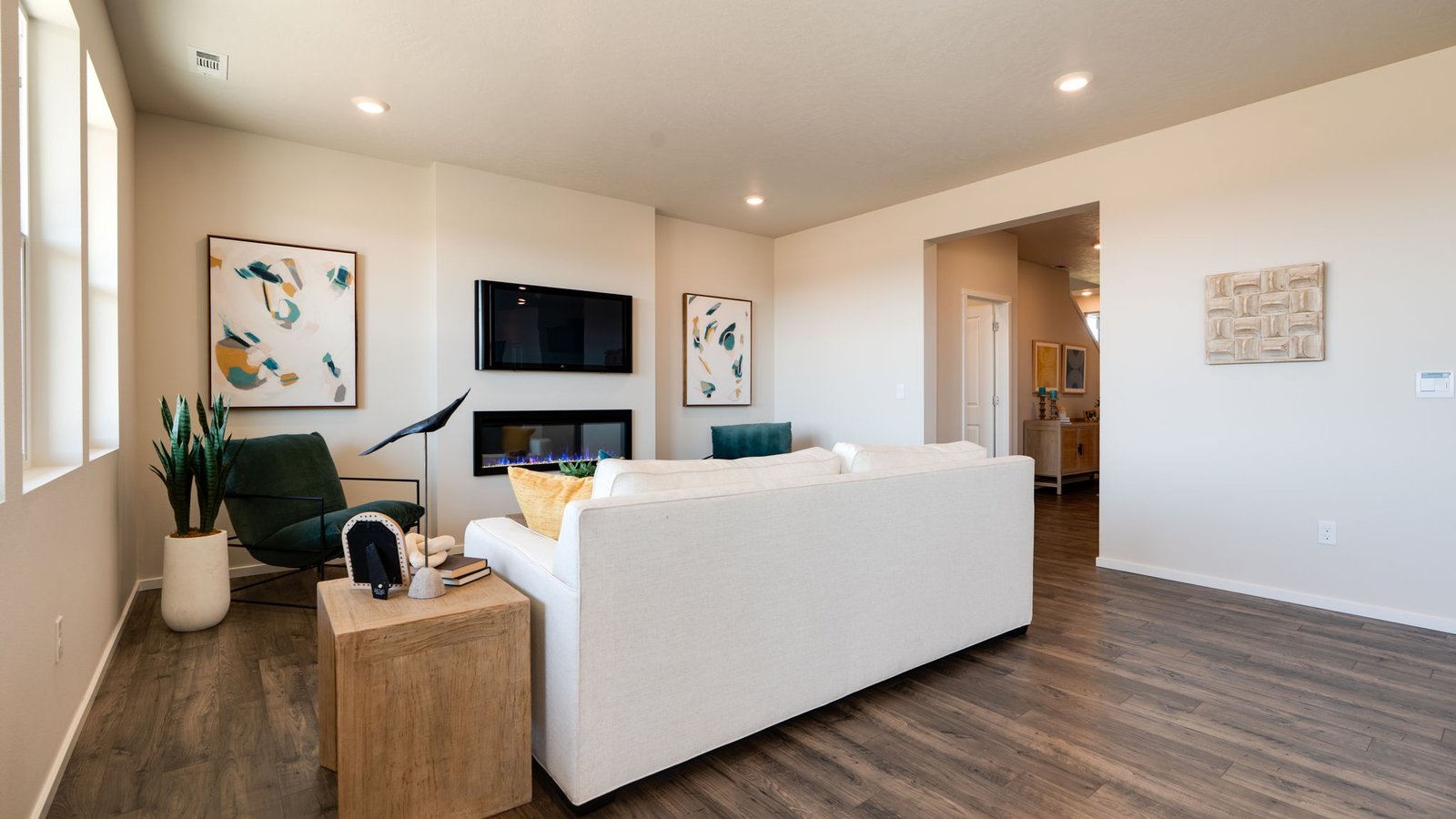 Great room with laminate flooring and an electric fireplace