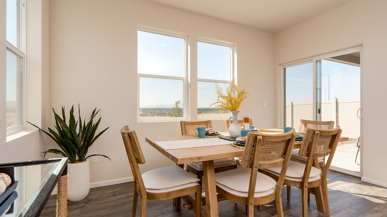 Dining area with a sliding glass door to a fenced backyard