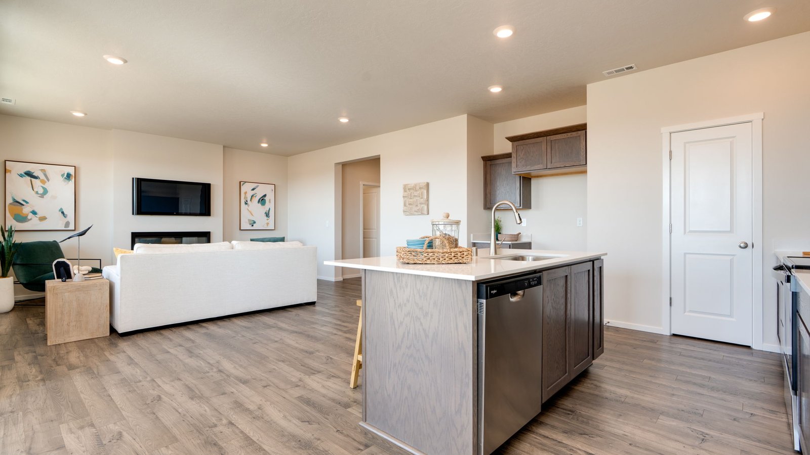 Kitchen with shaker cabinets, quartz counters, stainless steel appliances, pantry, and an island with a breakfast bar