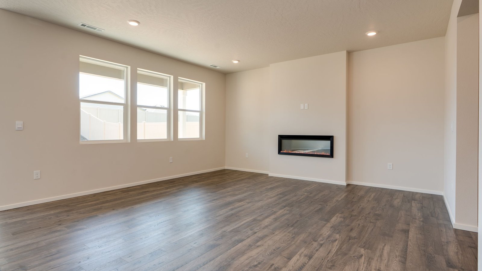 Great room with laminate flooring and an electric fireplace
