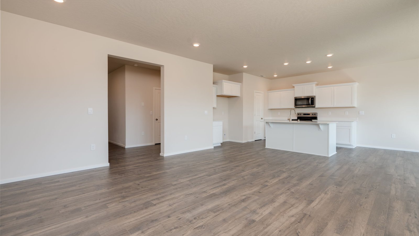 Great room with laminate flooring and an electric fireplace