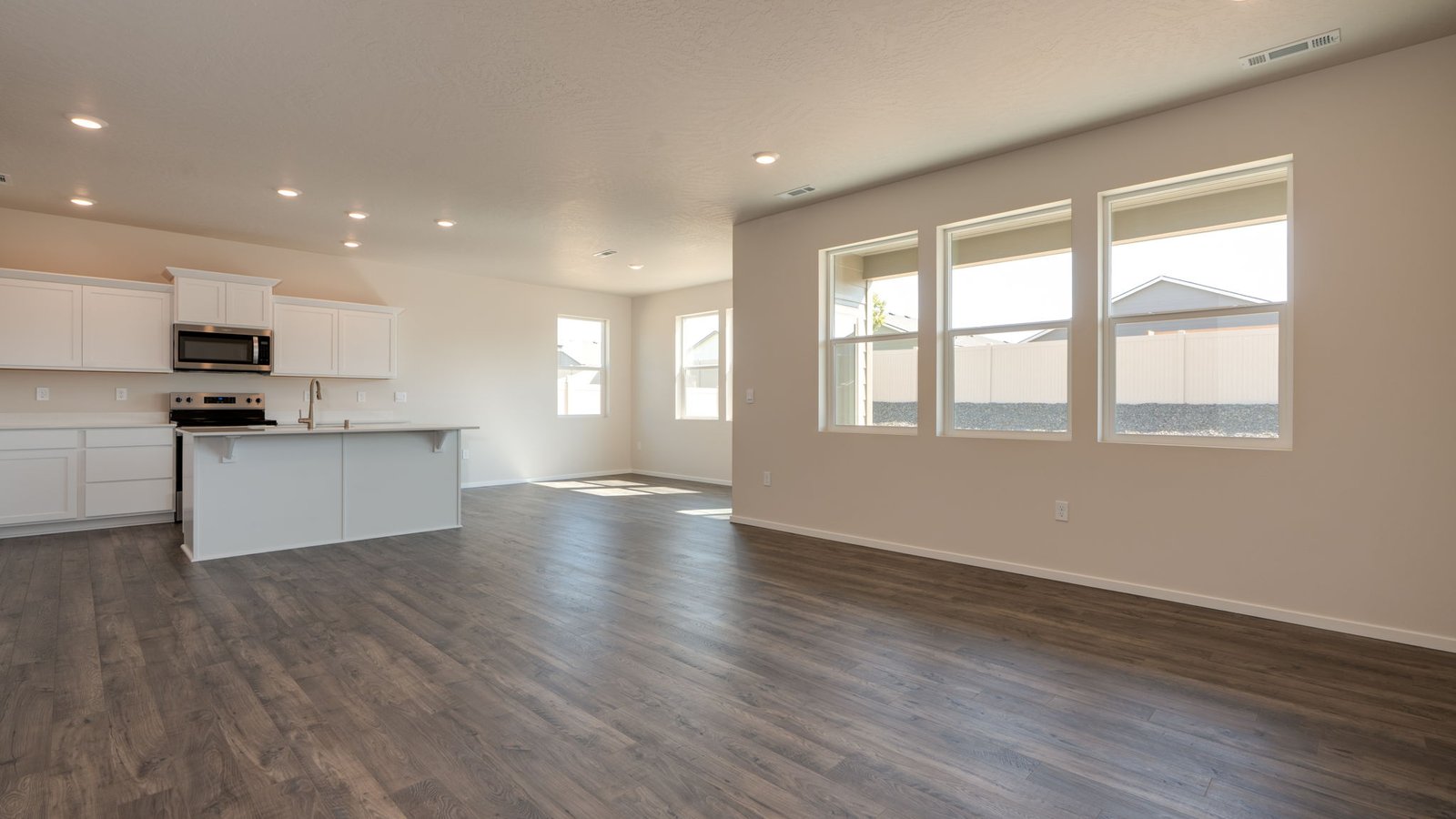 Great room with laminate flooring and an electric fireplace