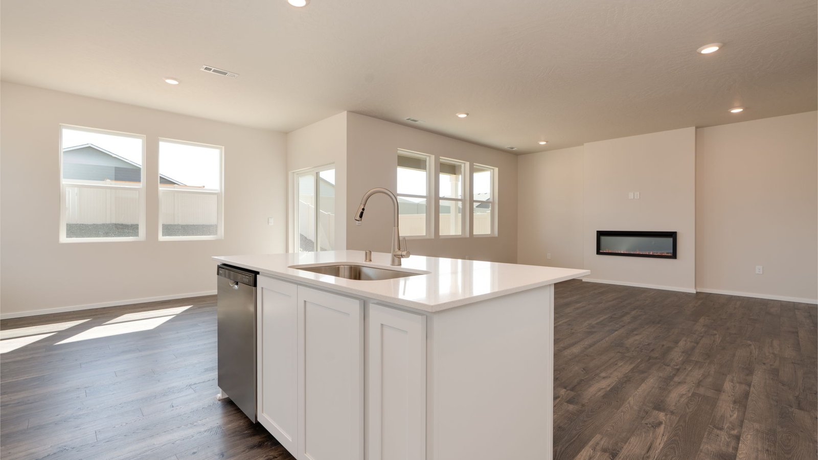 Kitchen with shaker cabinets, quartz counters, stainless steel appliances, pantry, and an island with a breakfast bar