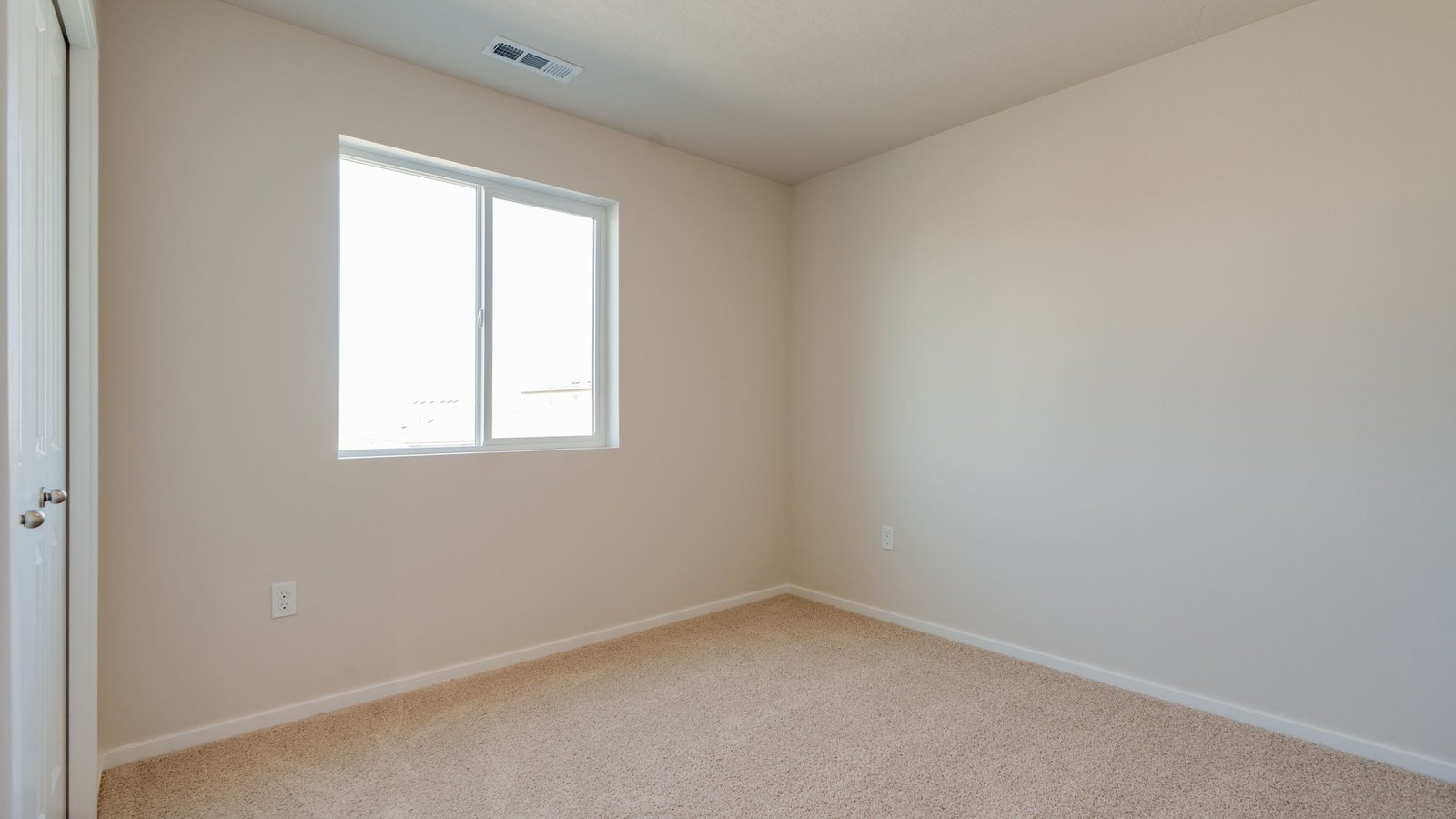 Bedroom with wall-to-wall carpet and a closet