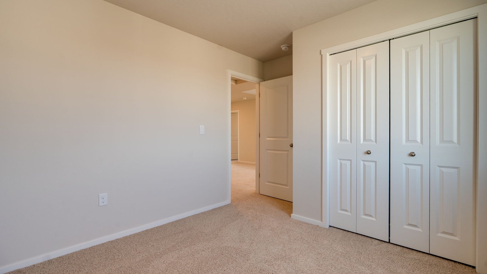 Bedroom with wall-to-wall carpet and a closet