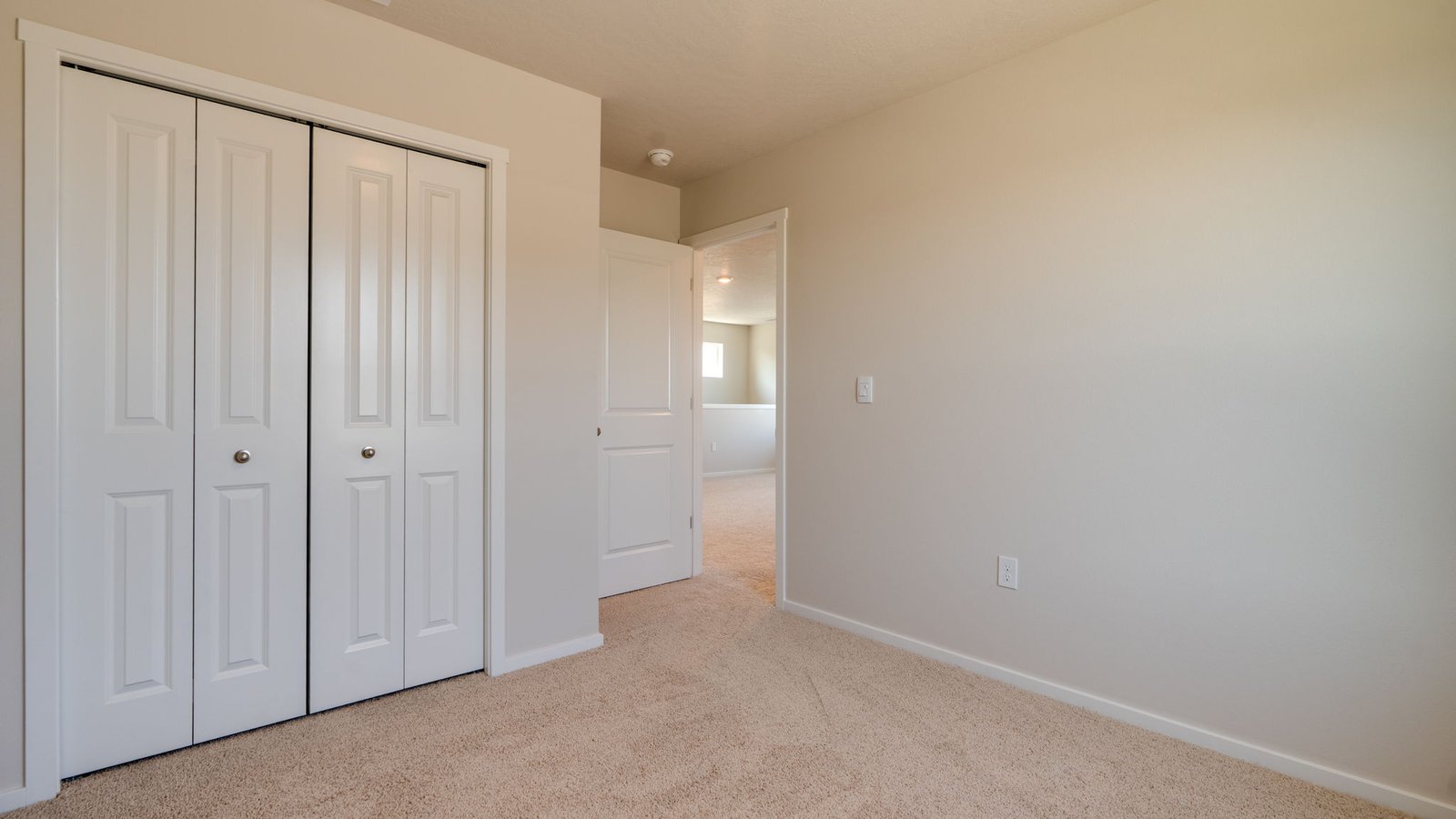 Bedroom with wall-to-wall carpet and a closet