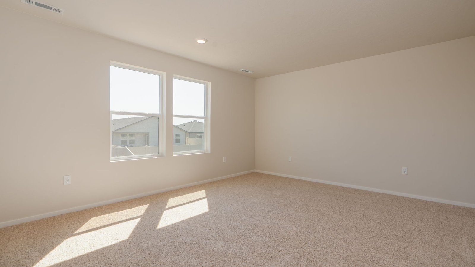 Primary bedroom with wall-to-wall carpet, a walk-in closet and an attached bathroom