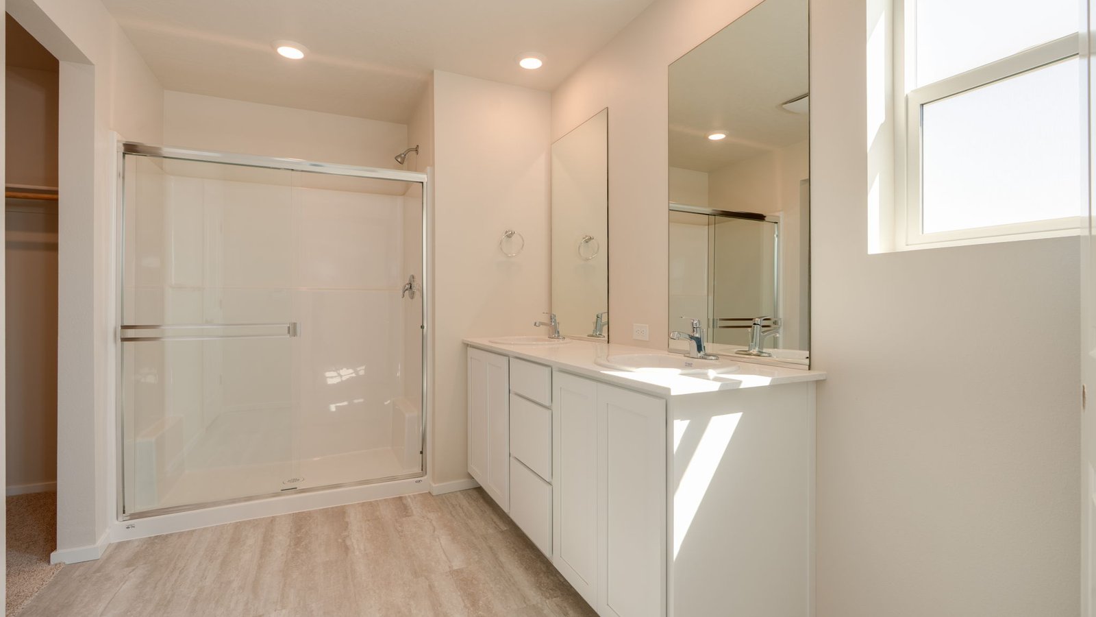 Primary bathroom with quartz counters and a walk-in shower