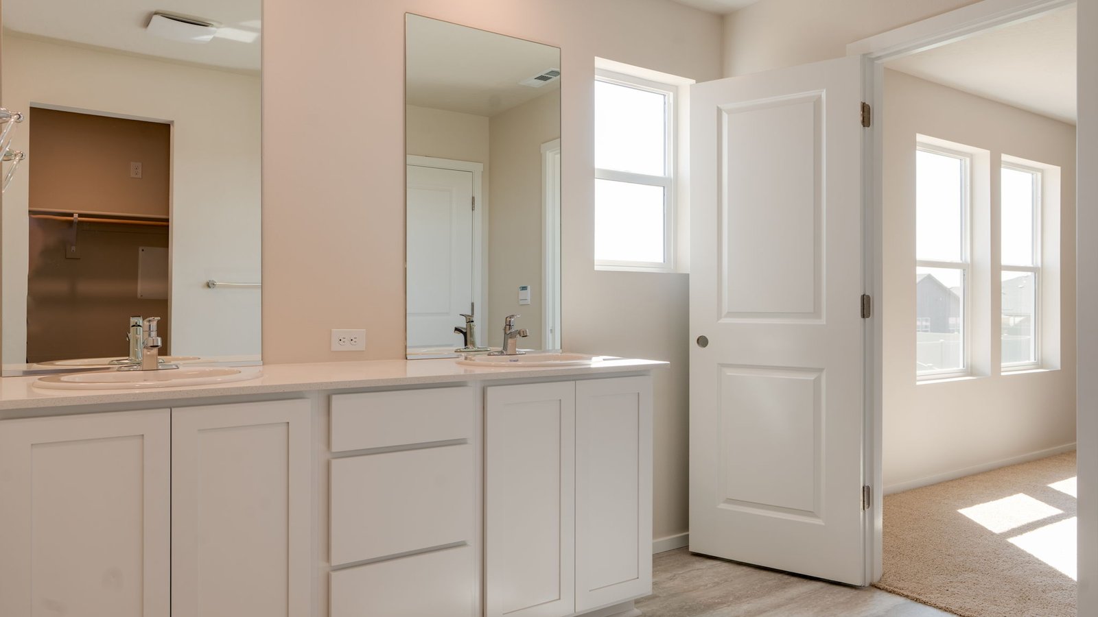 Primary bathroom with quartz counters and a walk-in shower