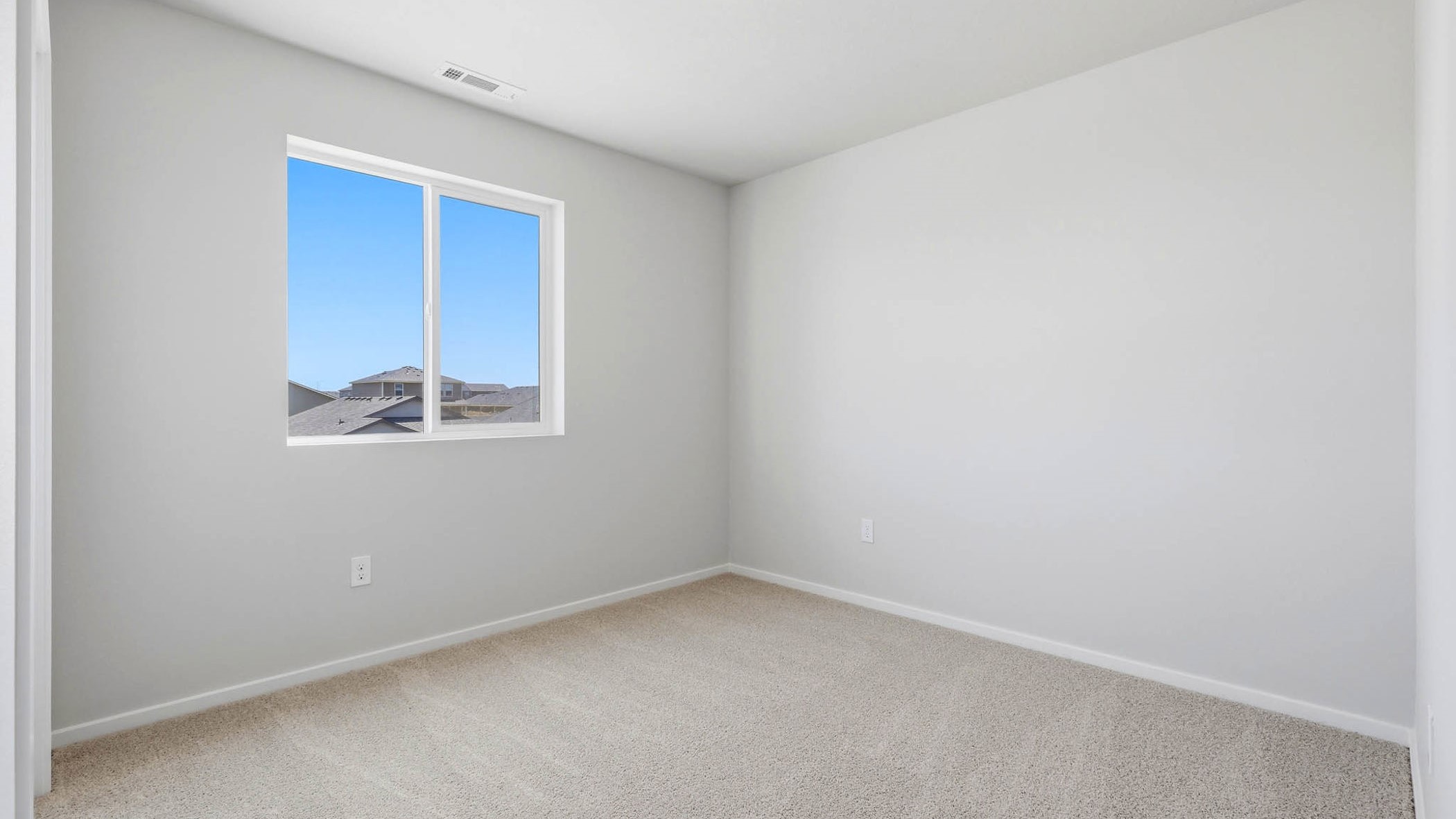 Bedroom with wall-to-wall carpet and a closet