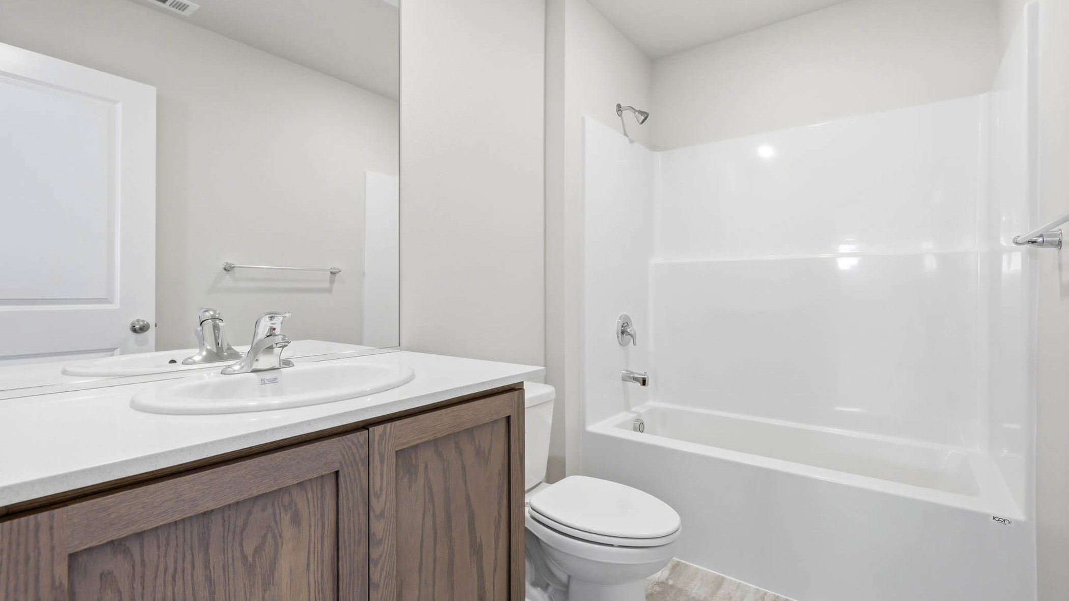 Hall bathroom with combination tub/shower and quartz counters
