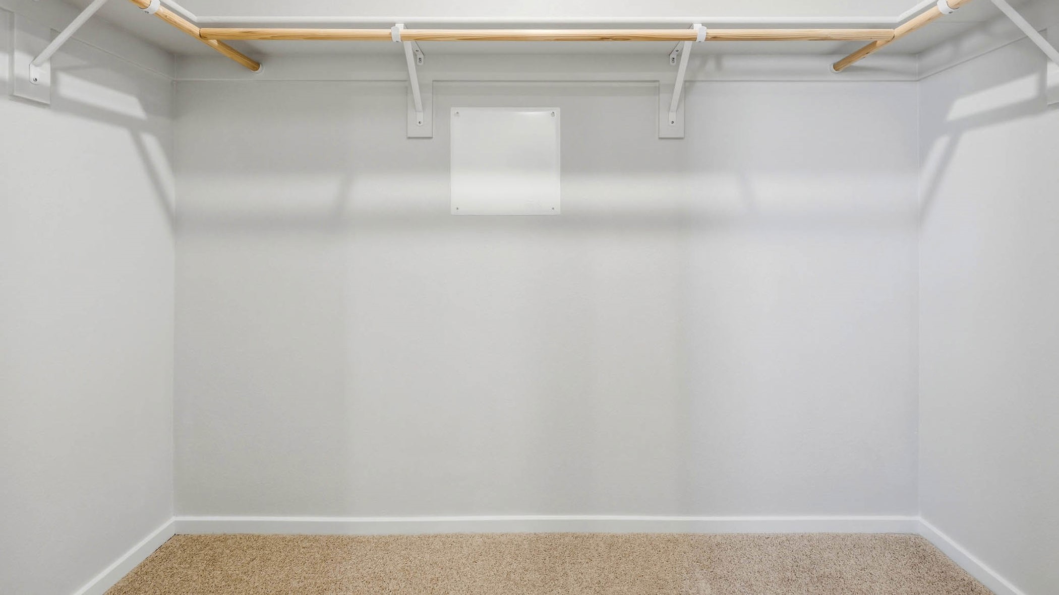 Primary bedroom walk-in closet with built-in shelves