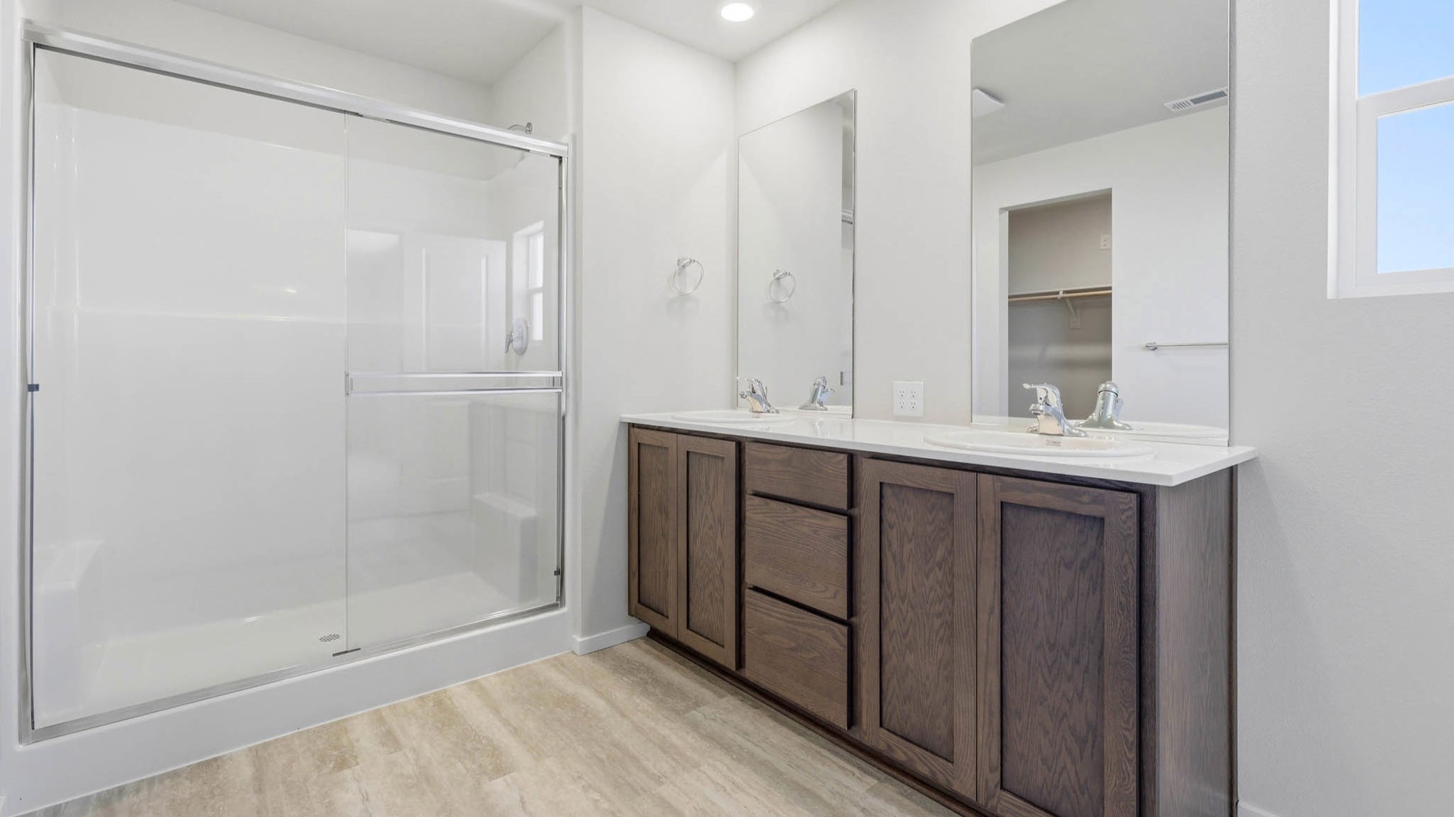 Primary bathroom with quartz counters and a walk-in shower