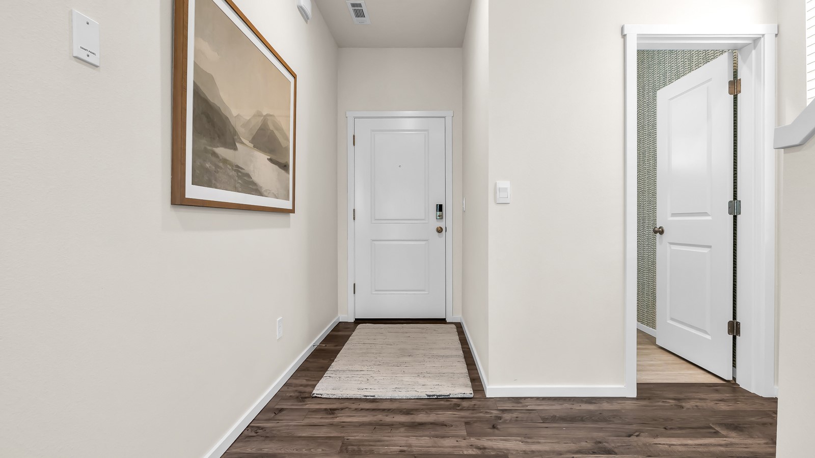 Entryway with a coat closet and laminate flooring