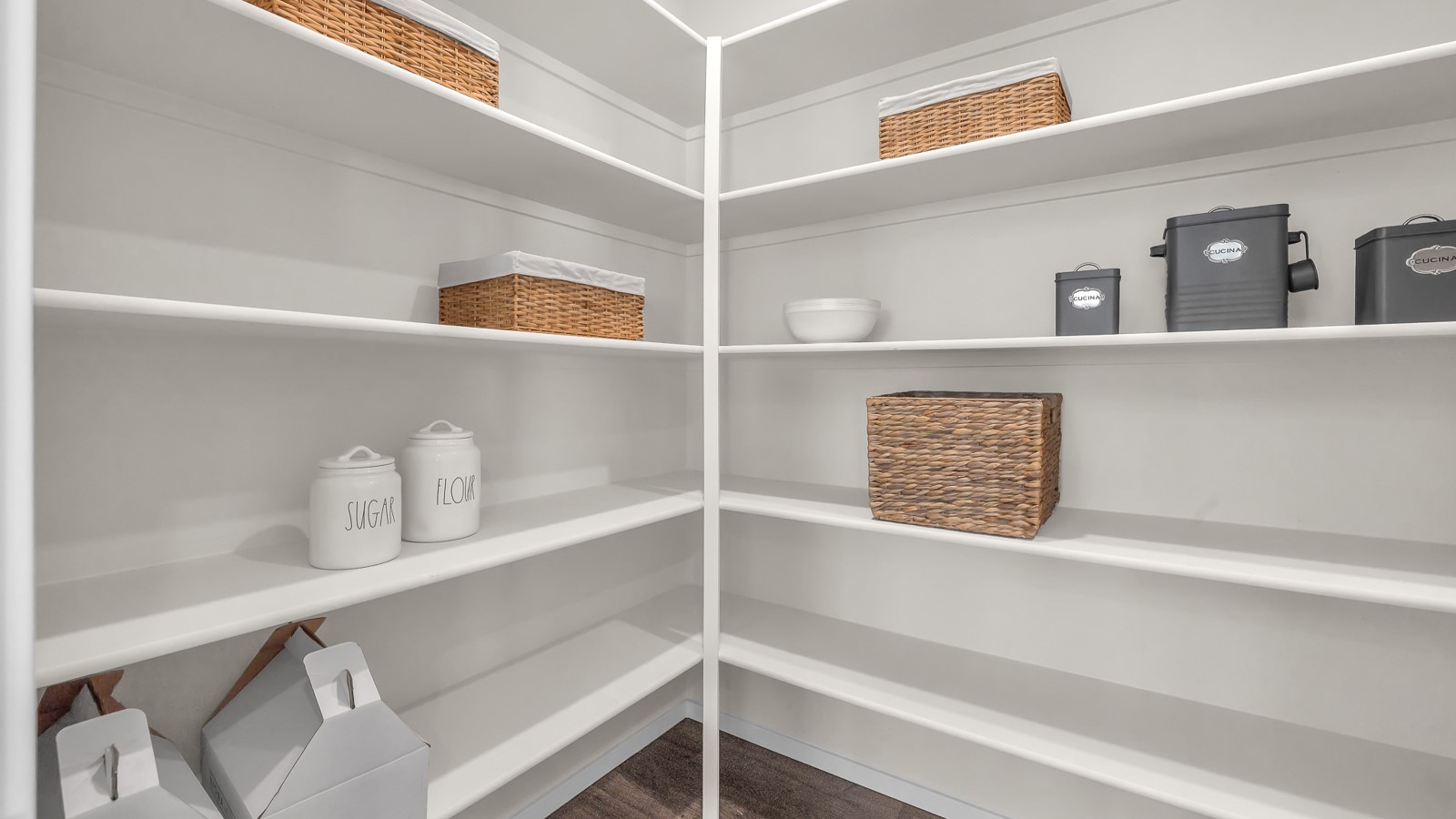 Kitchen with shaker cabinets, quartz counters, stainless steel appliances, pantry, and an island with a breakfast bar
