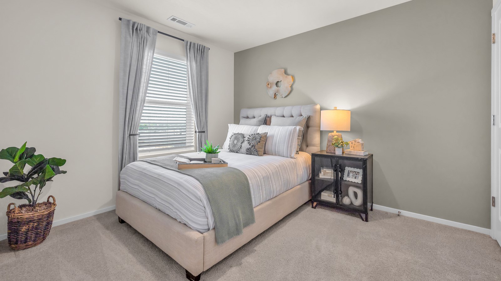 Bedroom with wall-to-wall carpet and a closet